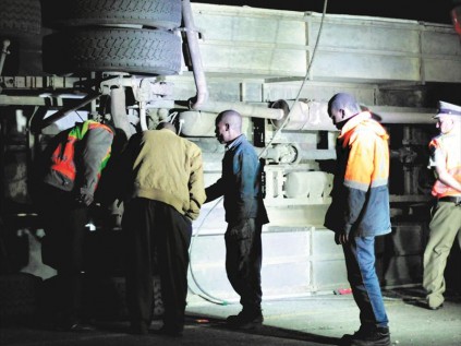 KZN Road Traffic Inspectorate officials check the under-carriage of the bus PHOTO: Larry Bentley