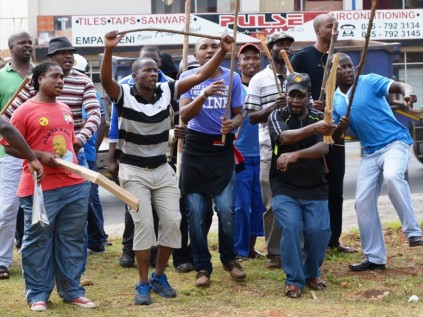 Strikers with sticks in hand refuse to back down