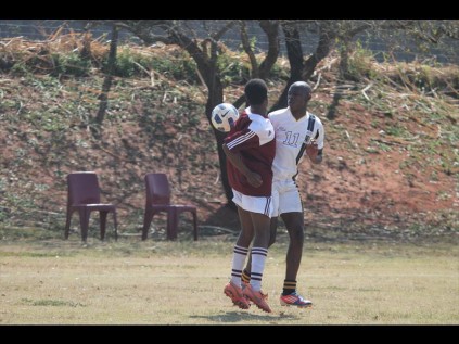 Ntuthuku Khumalo of John Ross College (maroon) and Mxolise Nene of Empangeni High School rubbed shoulders as they fought for ball possesion during their vital semi-final clash on SaturdayPHOTO: Richard Springorum