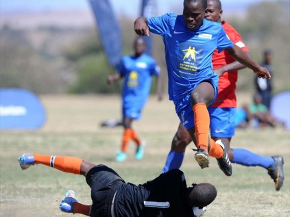 The Welabasha Secondary School (blue) attacker dodges the Sibongumusa Secondary School goal keeper as he tries to score during their vital clash