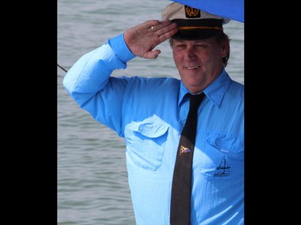 Zululand Yacht Club Commodore Rod Banwell takes the salute as boats pass by