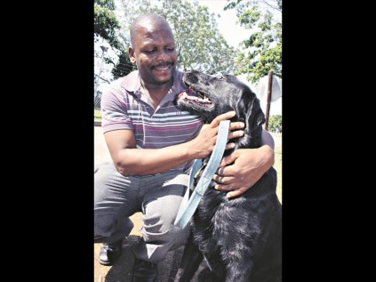 It's great to be back, buddy! A relieved Sergeant A Mthembu is reunited with his crime fighting partner Tjokkie at the Empangeni K9 Unit on Friday PHOTO: Ronelle Ramsamy