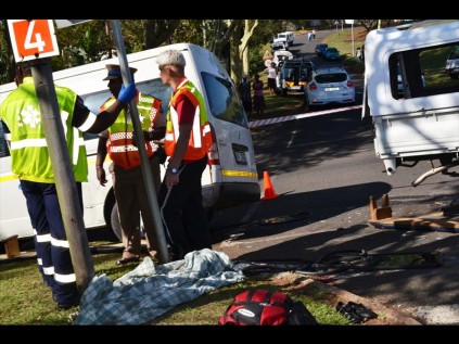 The body of a nine-year-old school child lies next to the road after she was flung out of a bakkie en route to school, following a collision with a taxi on President Swart Street in Empangeni on MondayPHOTO: Duschanka Hitzeroth
