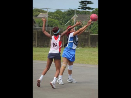 Nonkululeko Khumalo (blue) of the Ilembe district reaches for the ball as Siphiwesihle Buthelezi of the eThekwini district tries to stop her during their netball clash on Friday at the uMhlathuze Sports ComplexPHOTOS: Richard Springorum