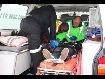 Netcare 911 paramedics attend to the fourth, badly wounded, suspect   