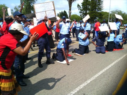 Staff at the protest on Saturday with signs in hand stating 'We are not going anywhere'