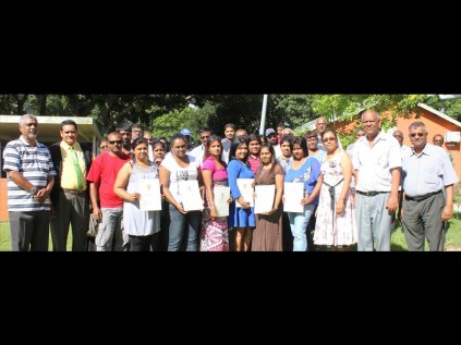 Residents of Brackenham proudly show off their newly-acquired title deeds