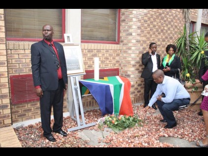 uThungulu District Municipality Deputy Mayor Thulani Mashaba looks on as members of the public lay flowers in memory of Madiba at uThungulu House in Richards Bay