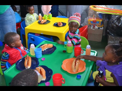 Toddlers happy to have tables and chairs in the new crèche