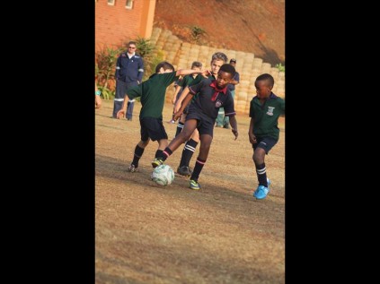 Mvelo Ndlovu dominates ball possession as three Grantleigh defenders try to tackle him