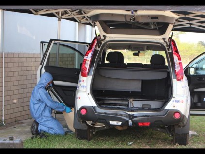 Police CSI forensic detective Sgt Niel van der Merwe combs the vehicle in search of clues and collects DNA samples at the Richards Bay police station on Tuesday
