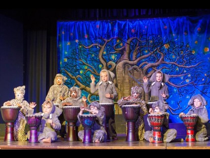 The Grade 1 class play the drums during a scene of The Elephant's Child