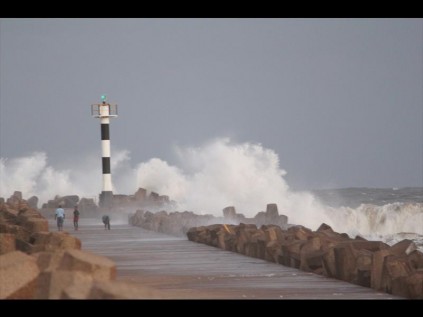 Waves lash the northern breakwater at Alkantstrand late Sunday afternoon