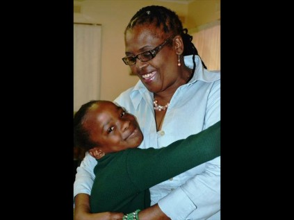 Siyakhanyisa Primary School Grade 3 pupil, Amanda Mthembu warmly embraces Zululand Hospice Association General Manager, Dr Sibongile Magagula.