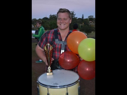 Excited drum line coach Daniel Swanepoel shows off the bands trophyPHOTO: Duschanka Hitzeroth