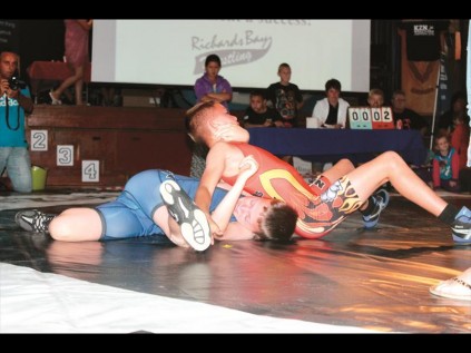 Make your move - Pierre Pieterse (red) from Richards Bay holds down Zander Steyn