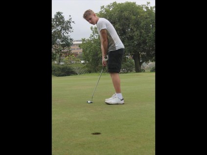 Torin Kleiner putts for par on the 14th