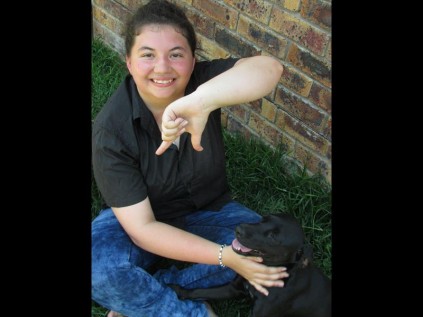 Cecilia signs her seven distinctions to dog Fuzzy  PHOTO: Mia Moorcroft