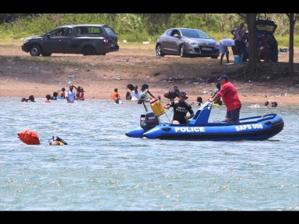 While bathers continue to enjoy their swim, police divers attempt to locate the body of the child drown victim on Saturday PHOTOS: DAVE SAVIDES