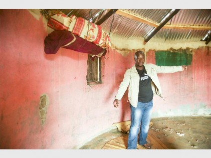 Nongoma resident Mduduzi Khoza points at the marks left on the wall from the ligntning storm PHOTOS: Senzelwe Mzila