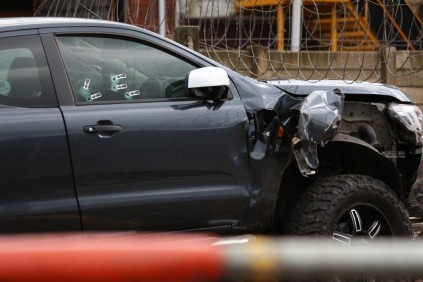 The occupant survived five gunshots at close range before losing control of the vehicle and crashing into a wall inside the Induna Logistics premises