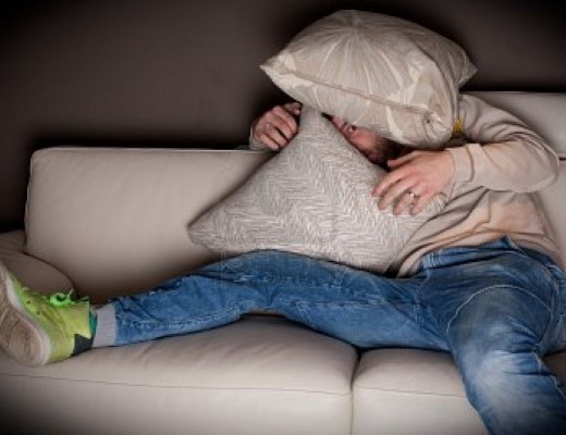 9687922-a-very-scared-man-watching-a-horror-movie-at-home