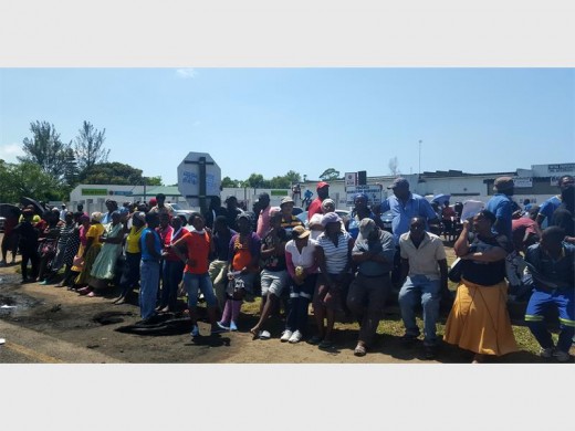 Scores of protesters patiently wait for a provincial government leader to arrive and accept their memorandum in Mzingazi