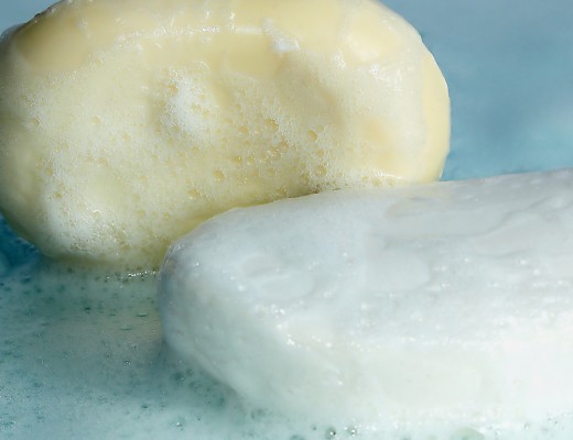 Yellow and white soap in foam but a blue backgroun