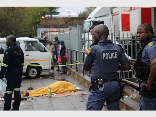 Warrant Officer Niren Ramsaroop lies dead near Power Spar in Empangeni. He was shot and killed by a suspect attempting to evade capture on 14 November 2015. Photo - Kyle Cowan