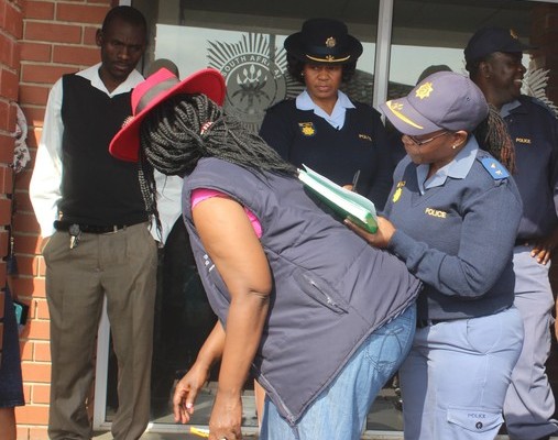 Police Commander Lt Col Mzimela signs the community's memorandum