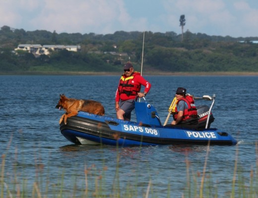 W/O Nico Gouws and W/O Waldo Herbst circle Lake Mzingazi with sniffer dog Cyrus looking to detect any sign or scent of a body in the water