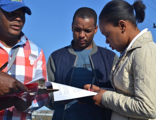 March coordinator Bongani Pearce hands over the memorandum of grievances to mine representatives Sizo Mkhize and Zama Zulu
