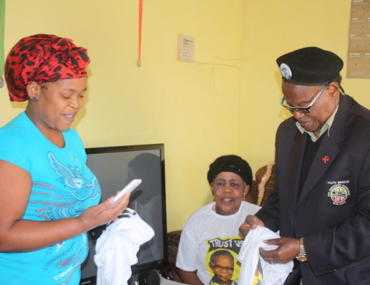 IFP leader iNkosi Mangosuthu Buthelezi hands out party T-shirts to Mbali and Dennis Thabethe of Jabulani Section in Ngwelezane during his door-to-door campaign