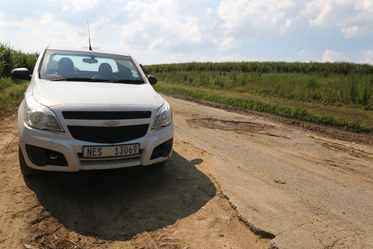 Motorists are forced to drive next to the road to avoid pot holes