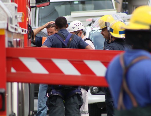 Construction workers, firefighters and paramedics at the scene of a crane hijacking in Richards Bay