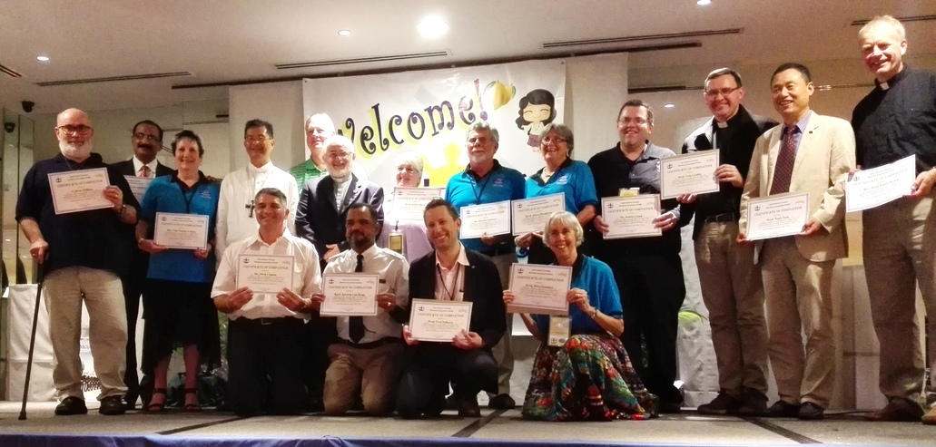 Mark Classen (front left) with a group receiving their certificates of completion